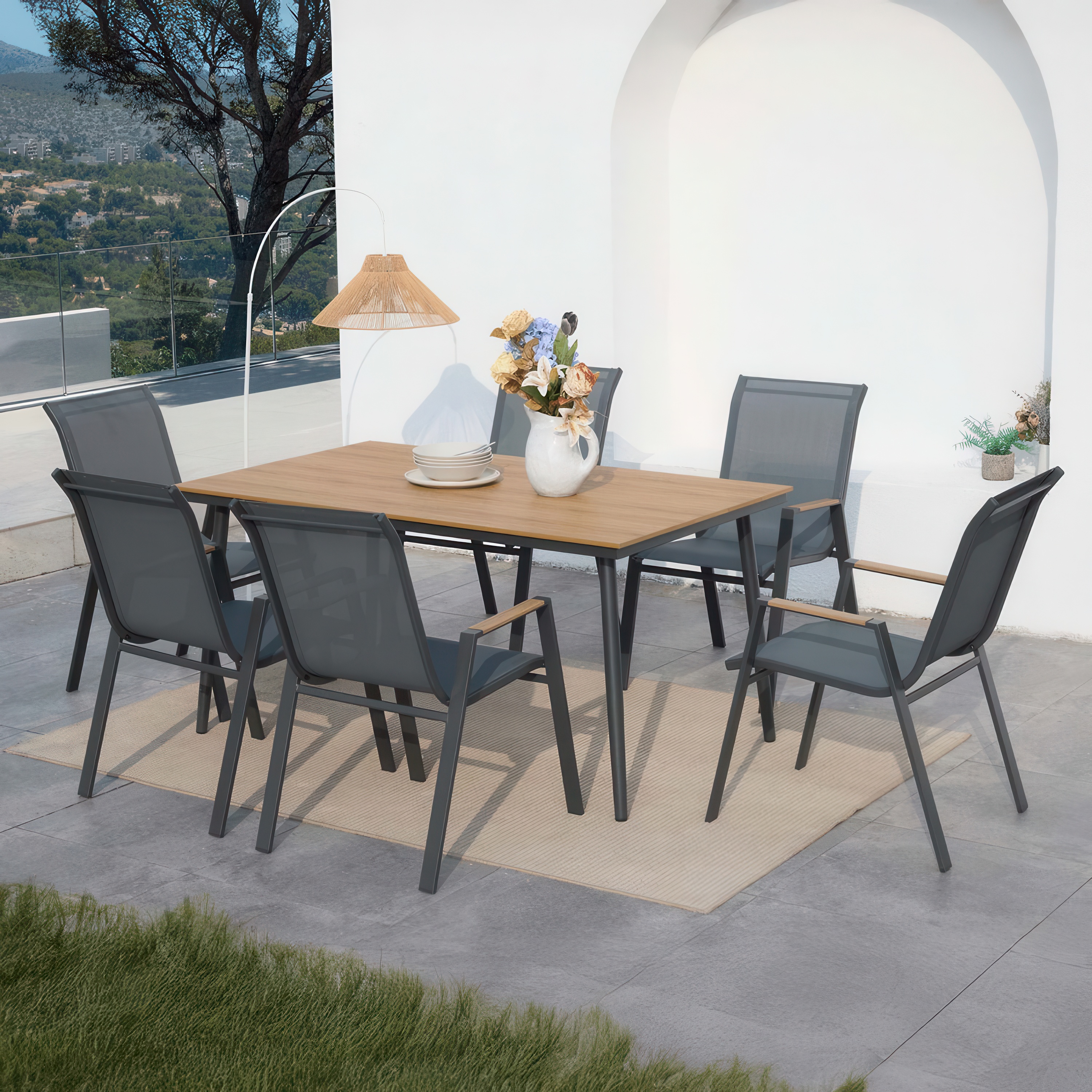 Zestaw mebli jadalnianych NOVA DINING 6+1 Dark Grey - aranżacja na tarasie, dzbanek z kwiatami na stole