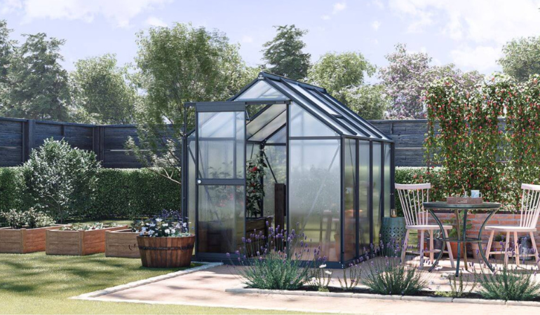 przestronna szklarnia ogrodowa w pięknie zaaranżowanym ogrodzie 