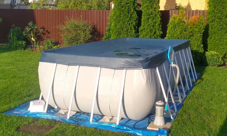 basen stelażowy w ogrodzie przykryty pokrywą basenową