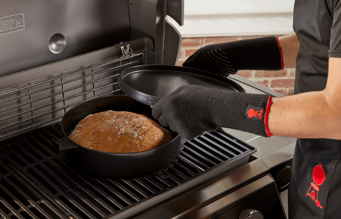 czarny kociołek grillowy umieszczony na palniku grilla z chlebem do upieczenia